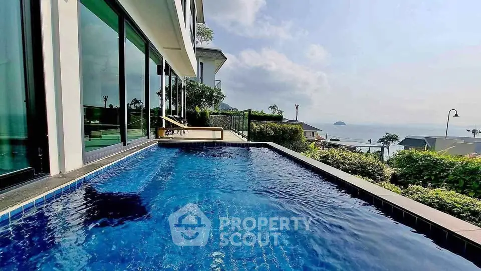 Luxurious poolside view with ocean backdrop in modern real estate property