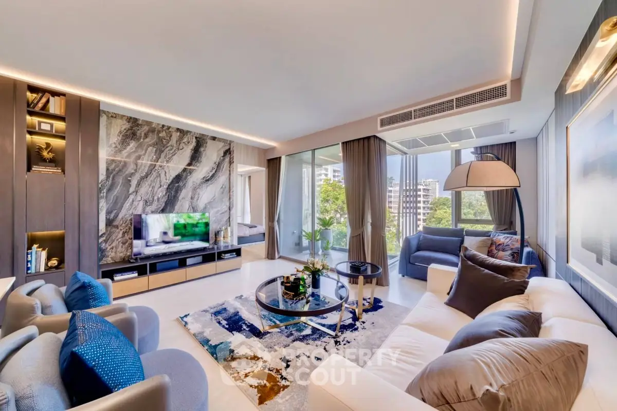Luxurious modern living room with elegant decor and large windows offering stunning city views.