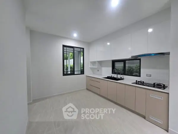 Modern kitchen with sleek cabinetry and gas stove in a bright, spacious layout.