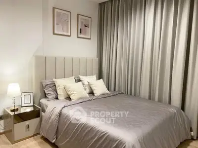 Elegant bedroom with modern decor, featuring a plush bed and stylish artwork.