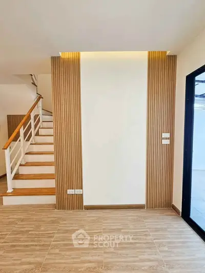 Modern interior with wooden staircase and stylish wall paneling