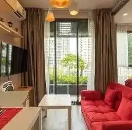 Modern living room with red sofa and balcony view in urban apartment