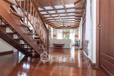 Spacious living room with wooden staircase and elegant decor