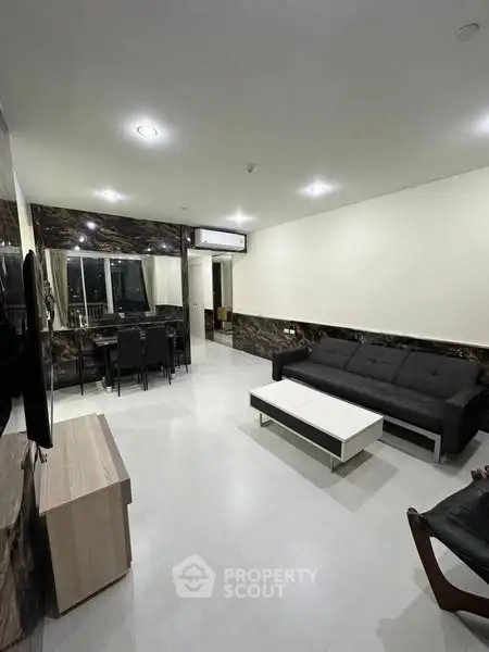 Spacious modern living room with sleek furniture and elegant lighting