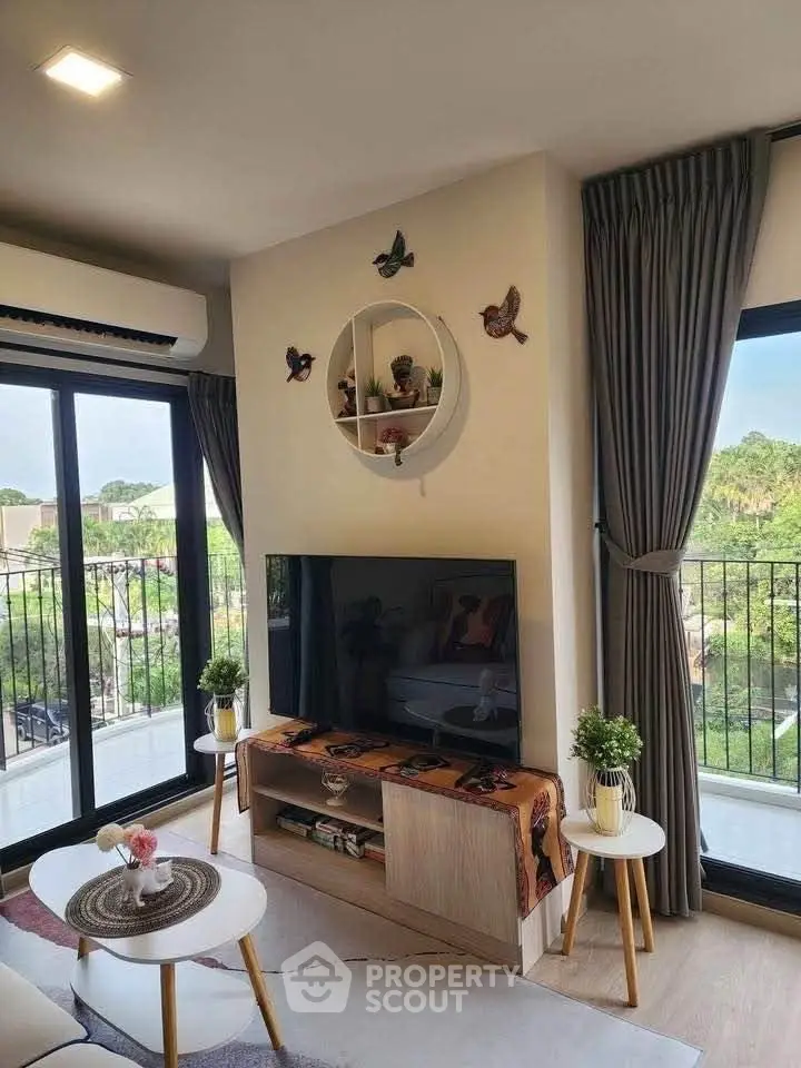 Charming living room with modern decor and balcony view, perfect for relaxation and entertainment.