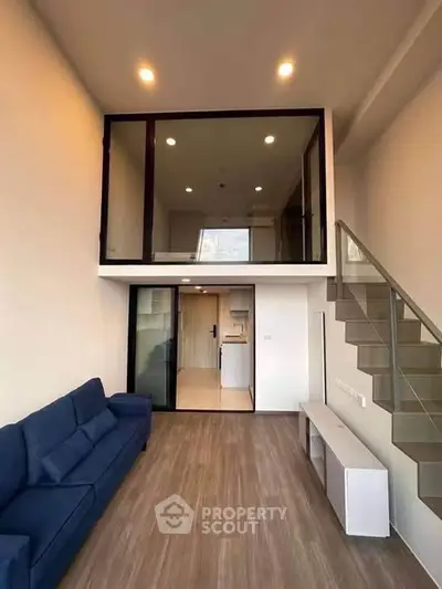 Modern duplex living room with high ceiling and stylish staircase