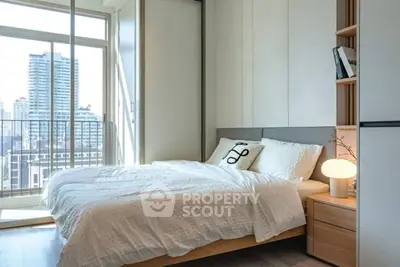 Modern bedroom with city view, featuring cozy bed and stylish decor in a high-rise apartment.