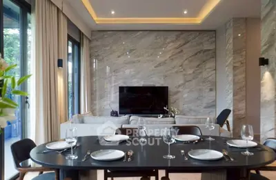 Luxurious modern living room with elegant dining area and marble accent wall