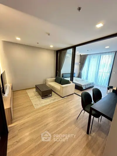 Modern open-plan living room with stylish furniture and natural light