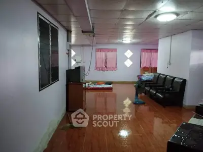 Spacious living area with tiled flooring and comfortable seating in a cozy home.