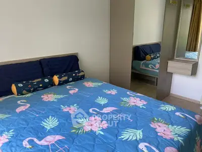 Cozy bedroom with vibrant flamingo-themed bedding and mirrored wardrobe