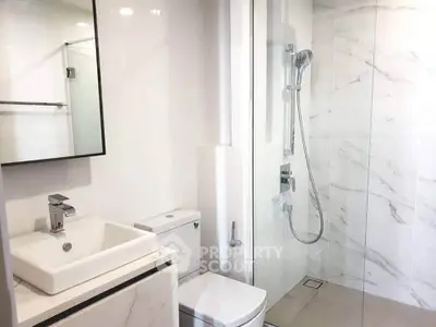 Modern bathroom with sleek fixtures and marble accents in a contemporary real estate property.