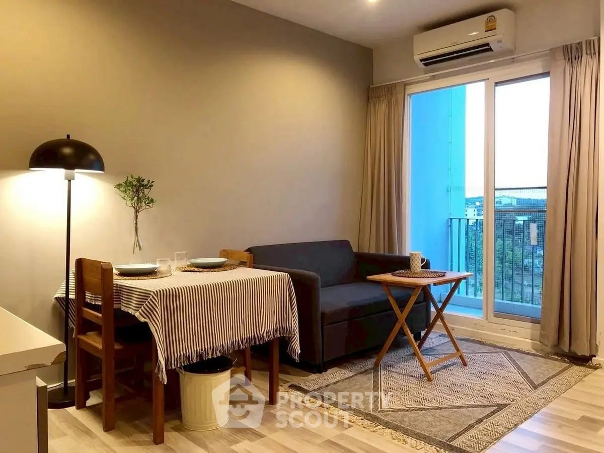 Cozy living room with dining area and balcony view in modern apartment