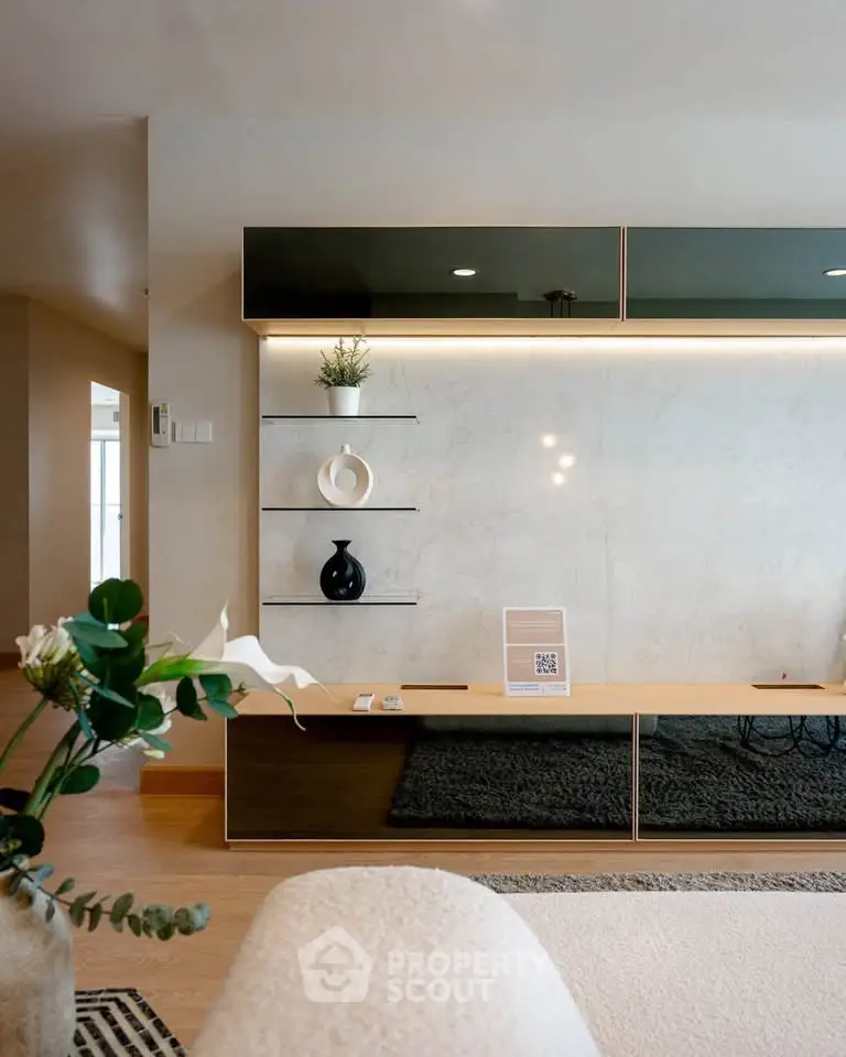 Modern living room with sleek shelving and elegant decor in a stylish apartment.