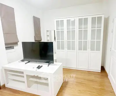Modern living room with sleek TV stand and elegant glass cabinet