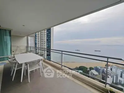 Spacious balcony with stunning ocean view in modern high-rise apartment