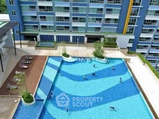 Luxurious apartment complex with stunning outdoor pool and modern architecture.