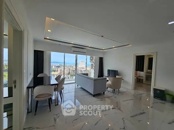 Spacious modern living room with stunning city view and elegant marble flooring.