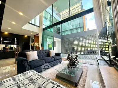 Luxurious modern living room with high ceilings and large windows