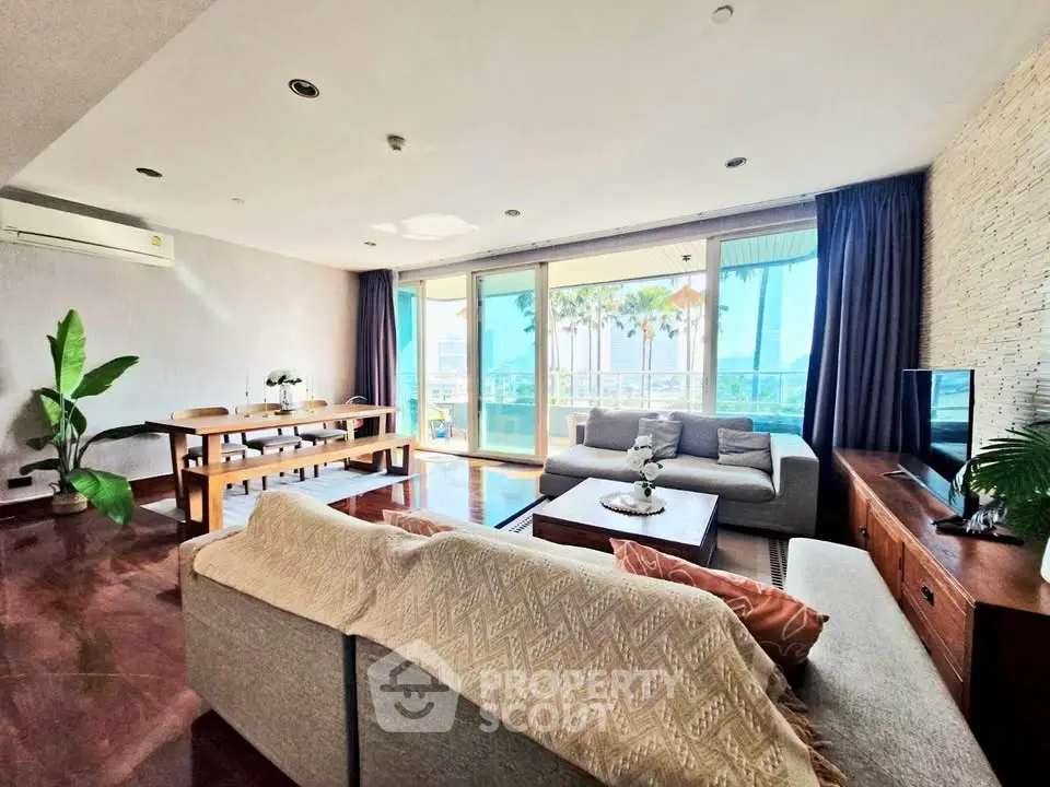 Spacious living room with modern decor and large windows offering stunning views.