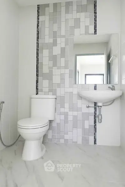 Modern bathroom with stylish tile design and sleek fixtures.