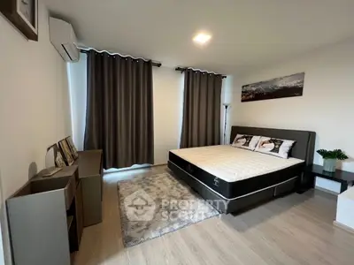 Modern bedroom with stylish decor and cozy atmosphere, featuring a comfortable bed and elegant furnishings.