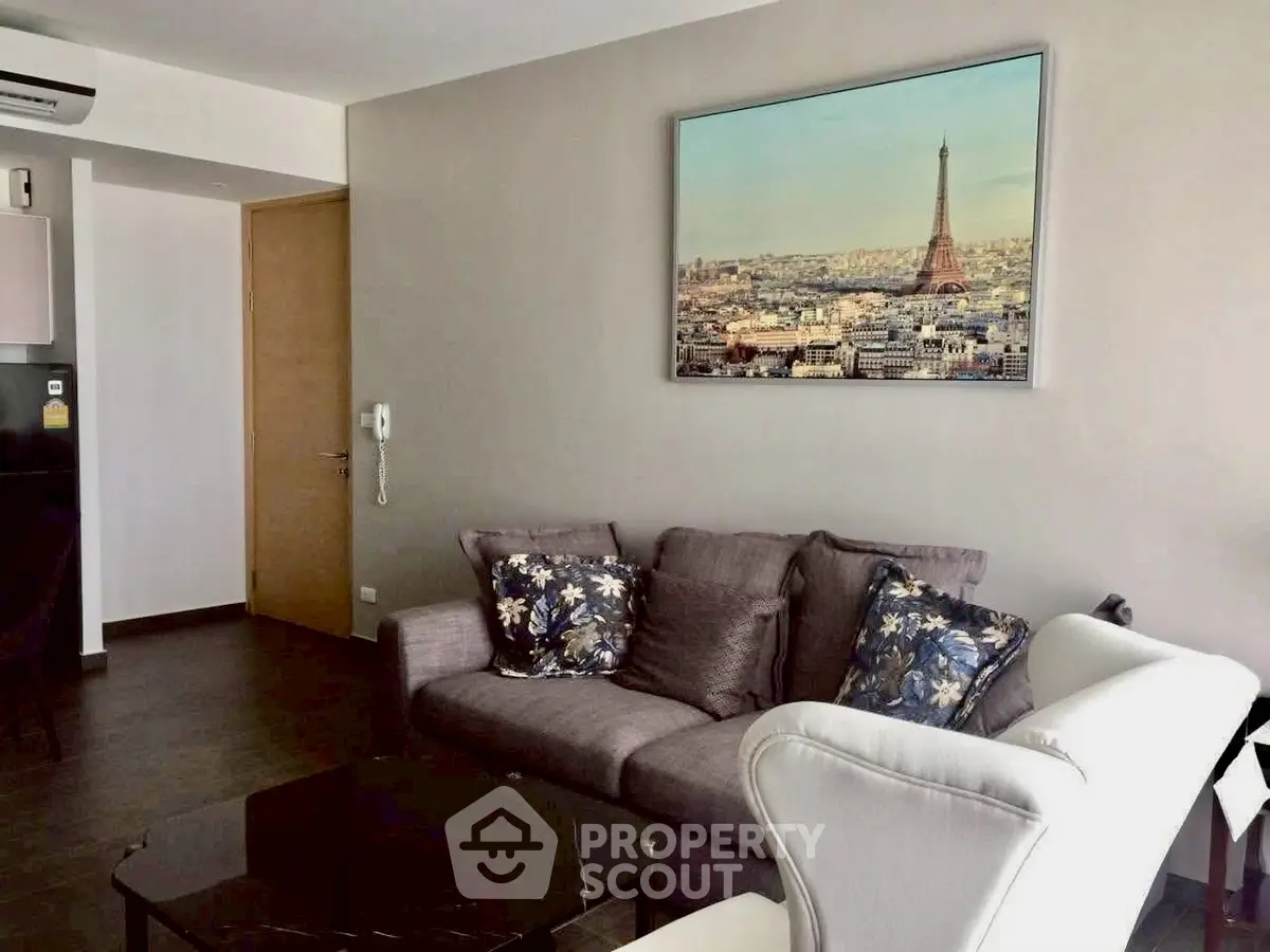 Modern living room with stylish decor and Paris-themed artwork