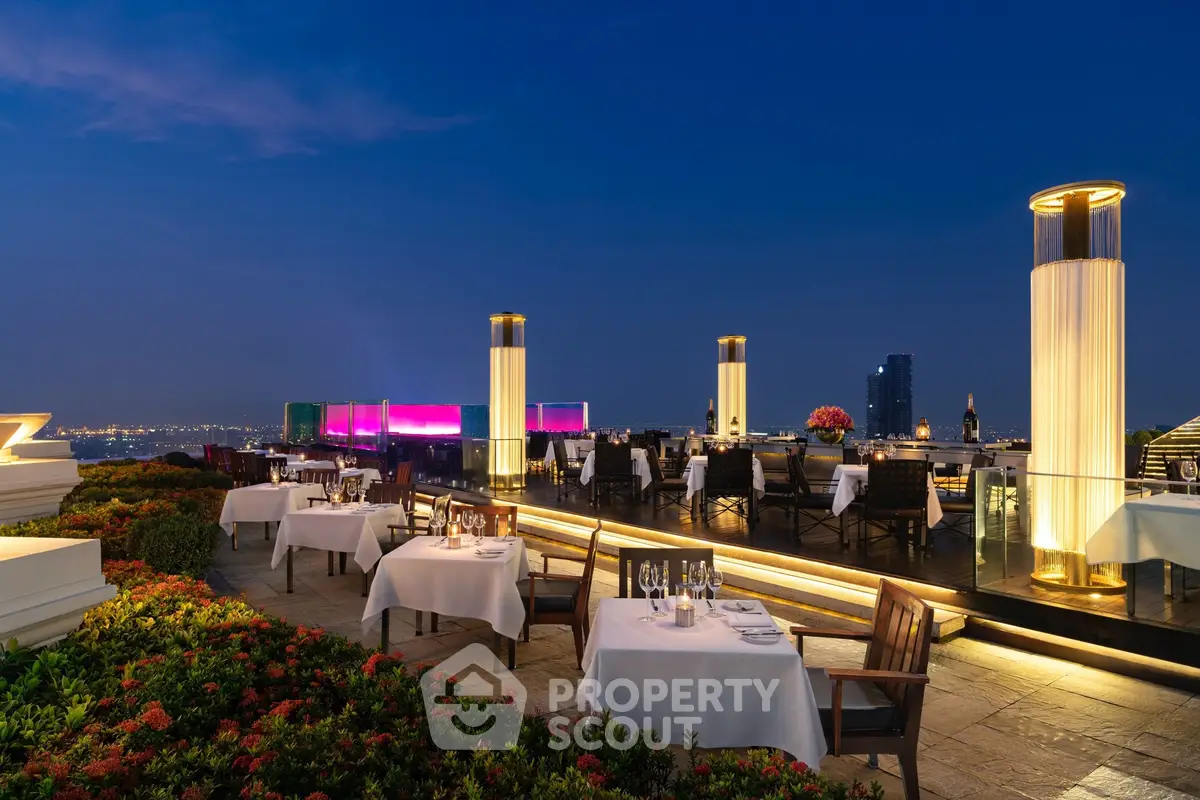 Luxurious rooftop dining area with stunning city skyline views and elegant table settings.
