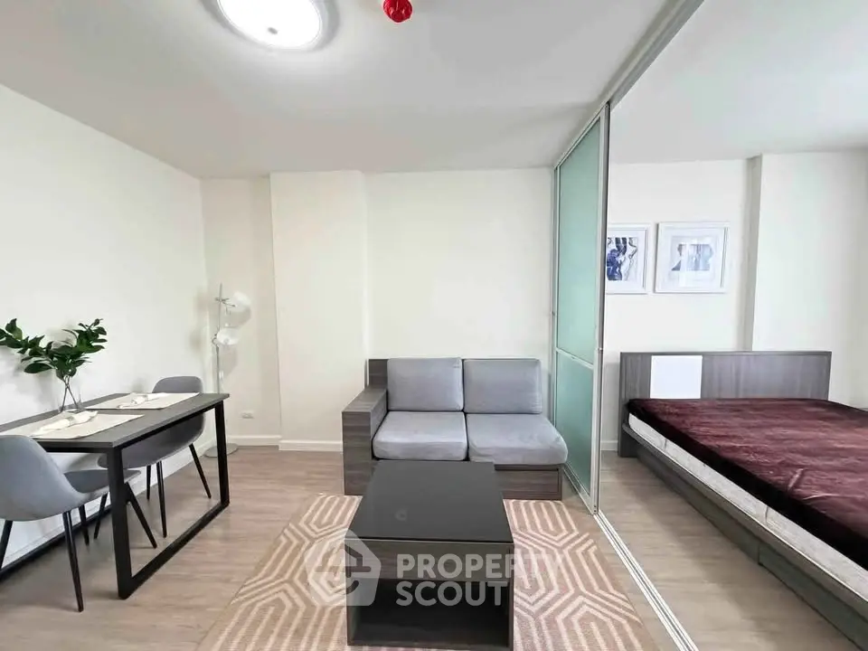 Modern studio apartment with sleek furniture and cozy decor, perfect for urban living.