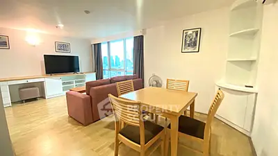 Spacious living room with city view, modern furniture, and natural light.