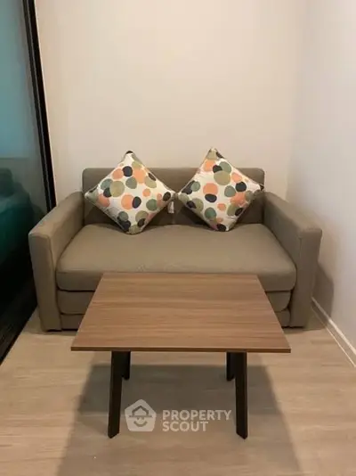 Cozy living room with modern sofa and stylish coffee table, perfect for relaxation.