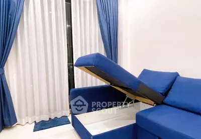 Modern living room with blue sofa and elegant curtains, featuring hidden storage space.