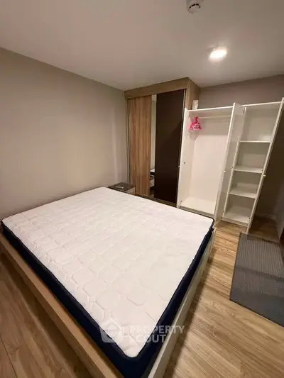 Modern bedroom with wooden flooring and spacious wardrobe
