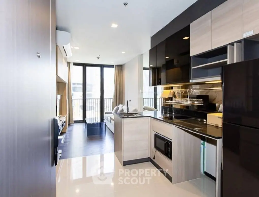 Modern open-layout kitchen with sleek cabinetry and living area view