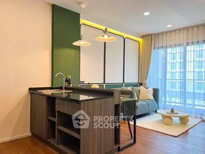 Modern living room with stylish open kitchen and large windows for natural light.