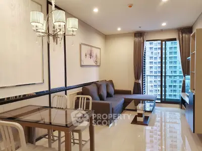 Modern living room with elegant decor and city view from large windows.