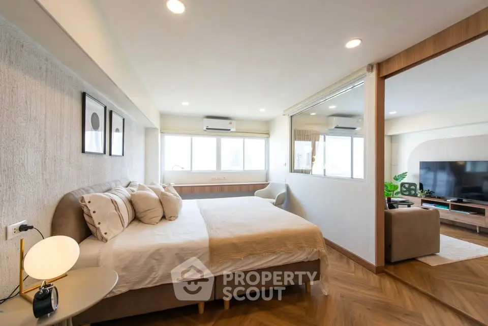 Spacious modern bedroom with elegant decor and natural light
