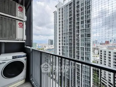 High-rise apartment balcony with city view and laundry area featuring a washing machine.
