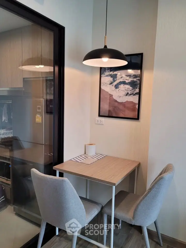 Cozy dining nook with modern decor and stylish lighting in a contemporary apartment.