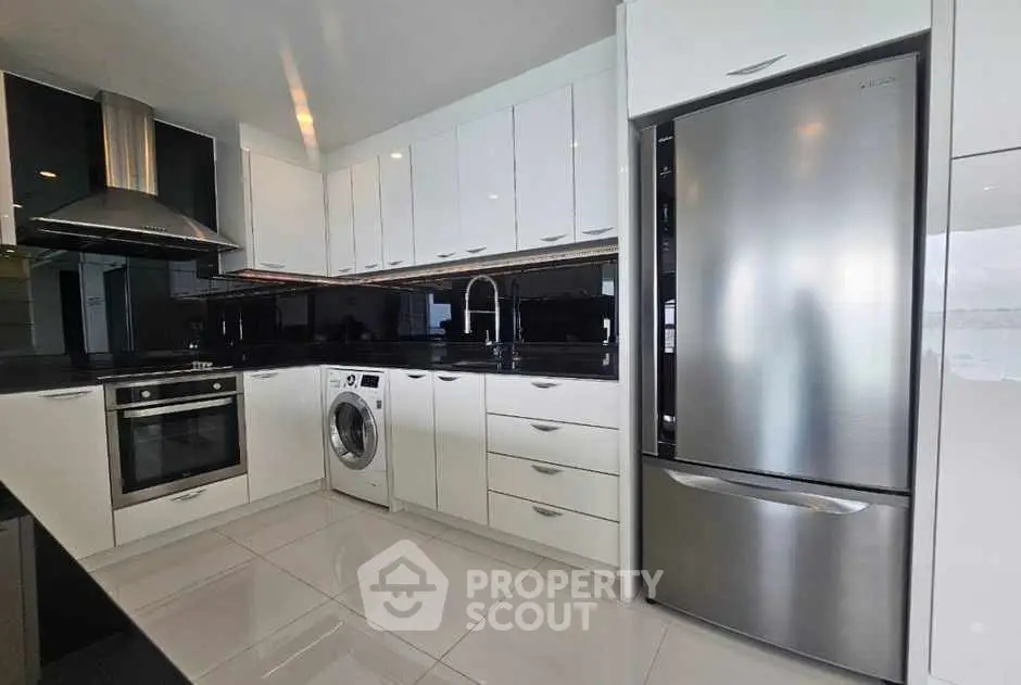 Modern kitchen with sleek appliances and glossy cabinetry