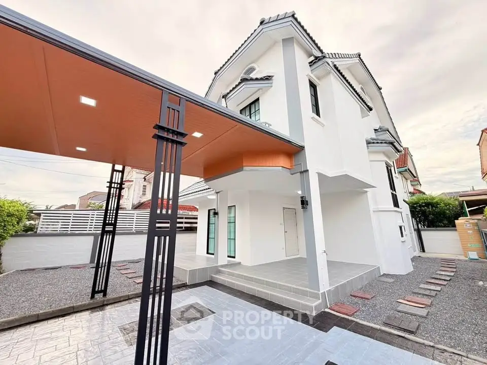 Modern two-story house with stylish carport and spacious outdoor area.
