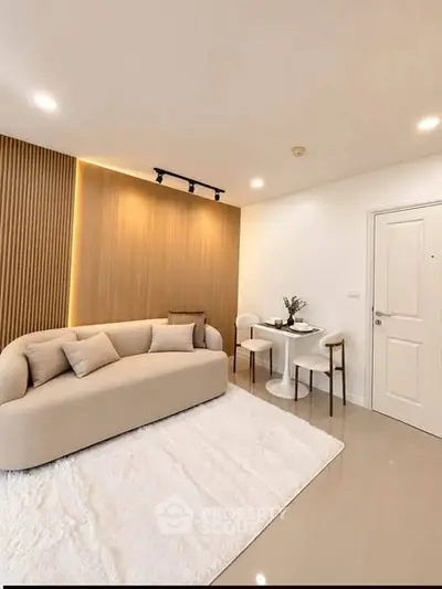 Modern living room with elegant beige sofa and stylish dining area
