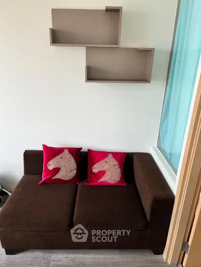 Cozy living room with brown sofa and unique horse-themed cushions