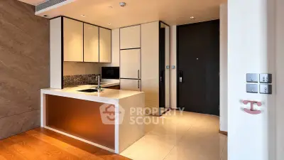 Modern kitchen with sleek cabinetry and integrated appliances in luxury apartment