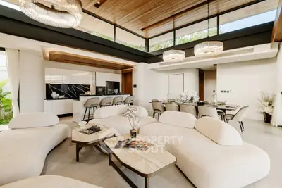 Luxurious open-plan living room with modern furniture and elegant dining area, featuring high ceilings and natural light.