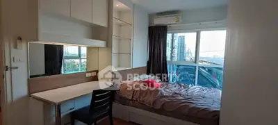 Cozy bedroom with city view, built-in desk, and ample storage in modern apartment.