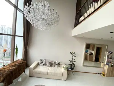 Luxurious living room with high ceilings and elegant chandelier in modern apartment