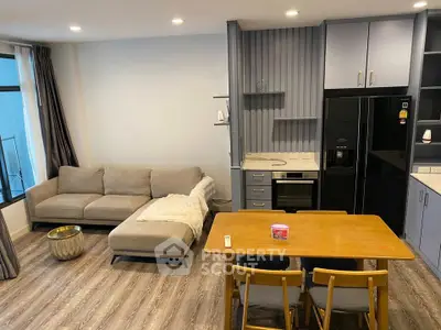 Modern living room with cozy sofa and stylish kitchen area