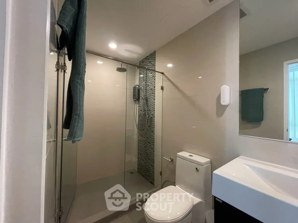 Modern bathroom with glass shower and sleek fixtures