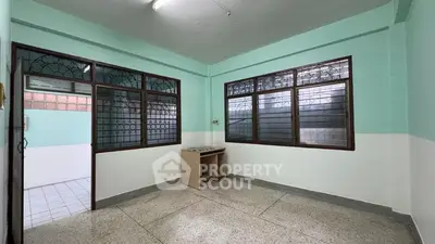 Spacious unfurnished room with large windows and natural light